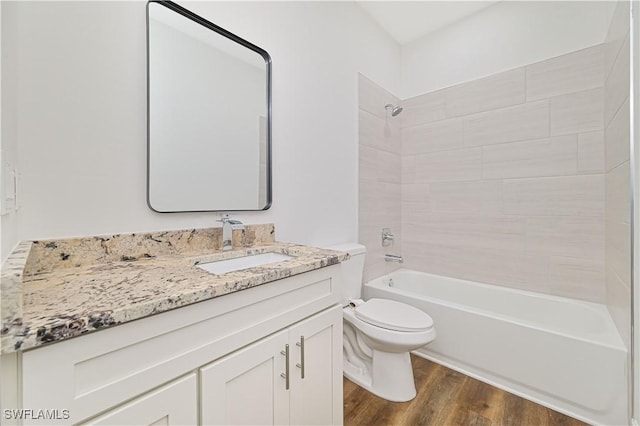 2174 Highland Ave, Fort Myers, FL 33916 - full bathroom featuring vanity, wood finished floors, toilet, and shower / bath combination