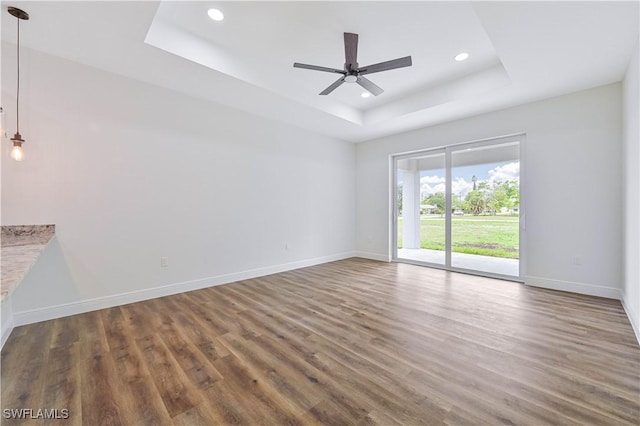 2174 Highland Ave, Fort Myers, FL 33916 - empty room with a tray ceiling, baseboards, wood finished floors, recessed lighting, and ceiling fan