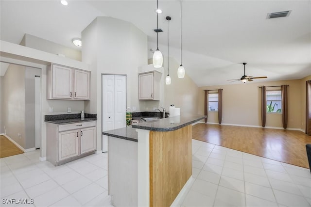 6731 Blake Pledger Ct, North Fort Myers, FL 33917 - kitchen featuring a sink, dark stone countertops, a ceiling fan, visible vents, and pendant lighting