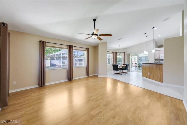 6731 Blake Pledger Ct, North Fort Myers, FL 33917 - unfurnished living room with baseboards, a ceiling fan, and light wood-style flooring