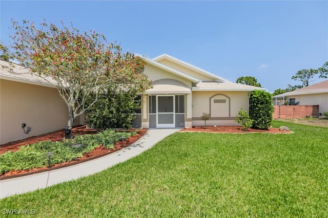 6731 Blake Pledger Ct, North Fort Myers, FL 33917 - view of front of property with fence, stucco siding, and a front yard