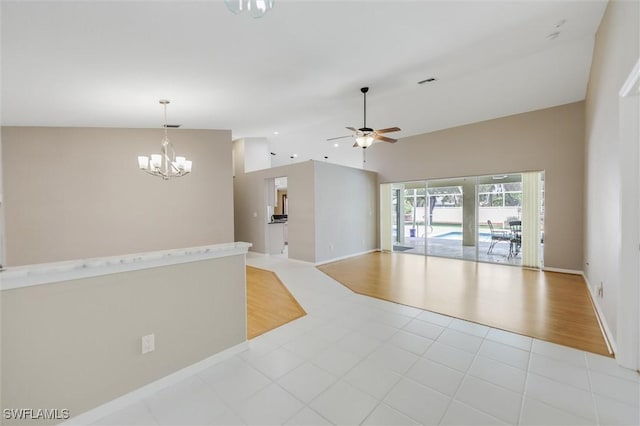 6731 Blake Pledger Ct, North Fort Myers, FL 33917 - interior space featuring baseboards, visible vents, ceiling fan with notable chandelier, and high vaulted ceiling