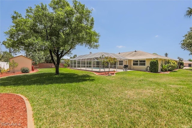 6731 Blake Pledger Ct, North Fort Myers, FL 33917 - view of yard with glass enclosure, an outdoor pool, and a patio area