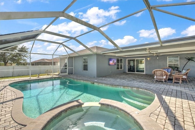 1137 Nelson Rd N, Cape Coral, FL 33993 - view of swimming pool featuring ceiling fan, a patio area, a pool with connected hot tub, and glass enclosure