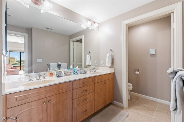 5781 Cape Harbour Dr Unit 610, Cape Coral, FL 33914 - bathroom featuring a sink, double vanity, toilet, and tile patterned flooring