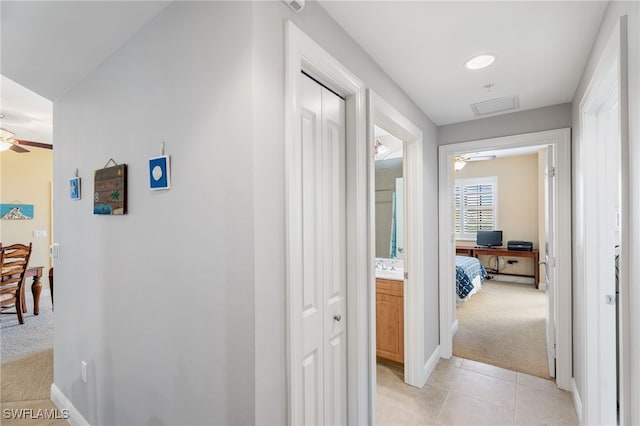 5781 Cape Harbour Dr Unit 610, Cape Coral, FL 33914 - corridor with light carpet, baseboards, and light tile patterned floors