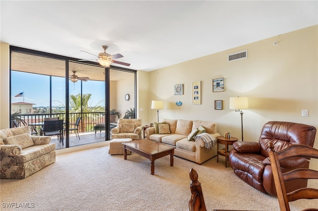 5781 Cape Harbour Dr Unit 610, Cape Coral, FL 33914 - living room with carpet flooring, floor to ceiling windows, visible vents, and a ceiling fan