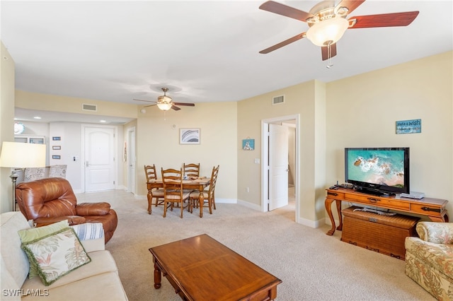 5781 Cape Harbour Dr Unit 610, Cape Coral, FL 33914 - living room with baseboards, visible vents, ceiling fan, and light colored carpet