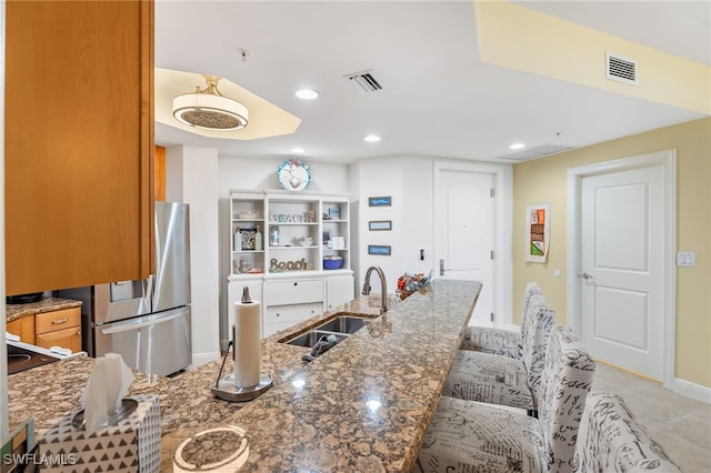 5781 Cape Harbour Dr Unit 610, Cape Coral, FL 33914 - kitchen featuring stainless steel fridge with ice dispenser, dark stone countertops, visible vents, and a sink