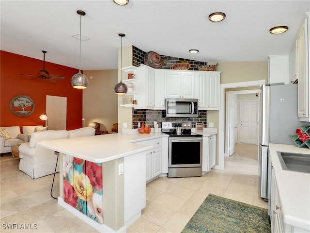 28902 Vermillion Ln, Bonita Springs, FL 34135 - kitchen featuring appliances with stainless steel finishes, a peninsula, open floor plan, backsplash, and white cabinetry