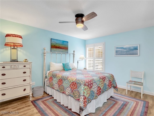 28902 Vermillion Ln, Bonita Springs, FL 34135 - bedroom featuring wood finished floors, a ceiling fan, and baseboards