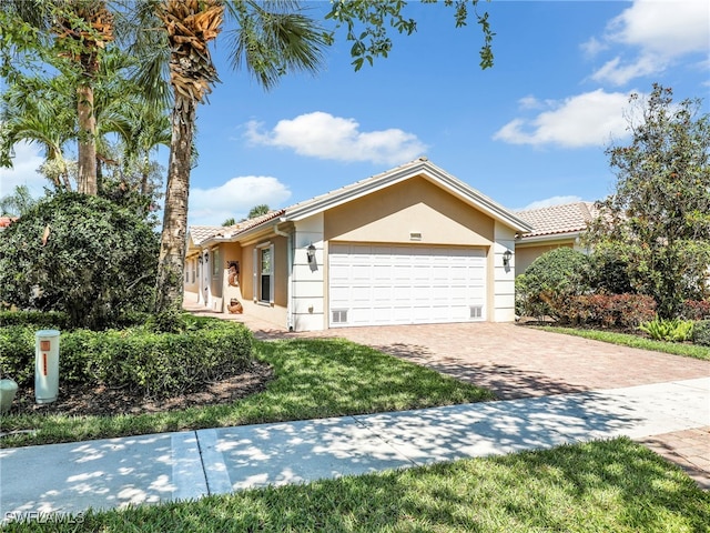 28902 Vermillion Ln, Bonita Springs, FL 34135 - single story home with an attached garage, stucco siding, driveway, and a tile roof
