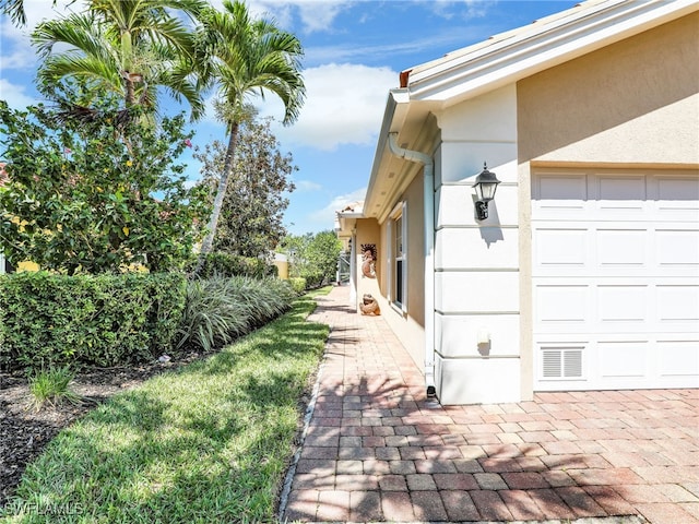 28902 Vermillion Ln, Bonita Springs, FL 34135 - view of property exterior featuring stucco siding and an attached garage