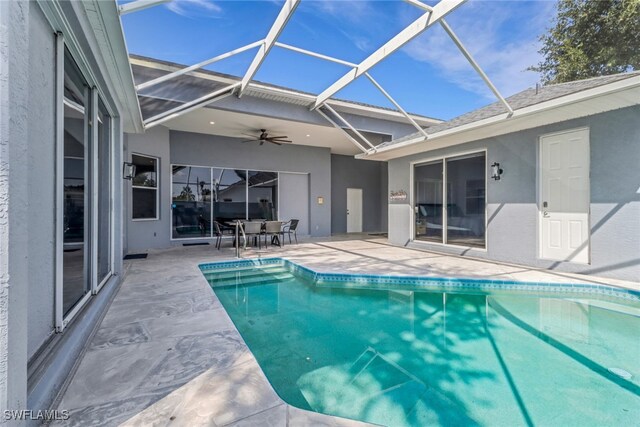 14831 Blackbird Ln, Fort Myers, FL 33919 - swimming pool featuring a patio, ceiling fan, glass enclosure, and outdoor dining area