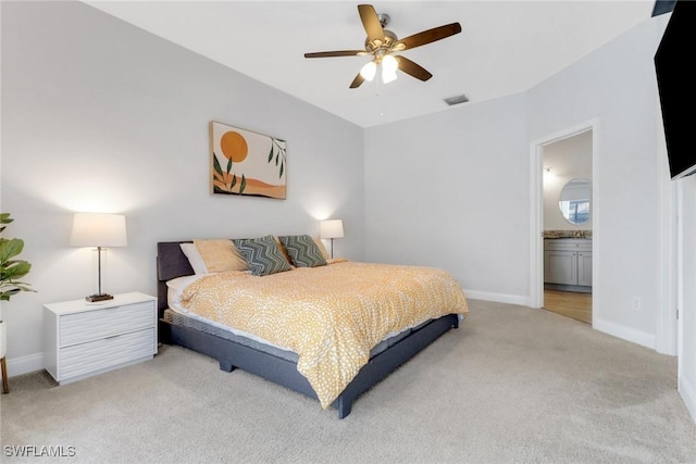 14831 Blackbird Ln, Fort Myers, FL 33919 - bedroom with light colored carpet, baseboards, ensuite bath, and ceiling fan