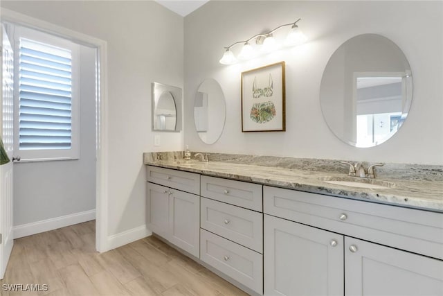 14831 Blackbird Ln, Fort Myers, FL 33919 - bathroom with double vanity, baseboards, and healthy amount of natural light
