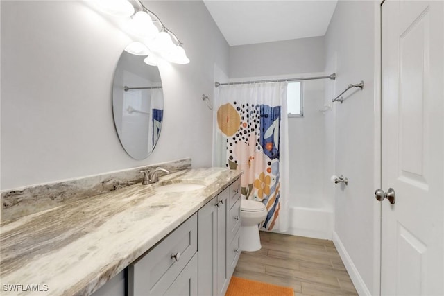 14831 Blackbird Ln, Fort Myers, FL 33919 - full bathroom with vanity, wood finished floors, shower / tub combo with curtain, toilet, and baseboards
