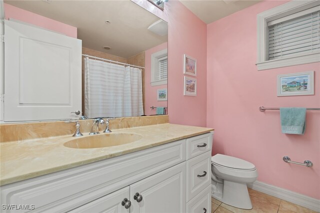 3414 Hancock Bridge Pkwy Unit 502, North Fort Myers, FL 33903 - bathroom featuring tile patterned flooring, vanity, toilet, baseboards, and a shower with curtain