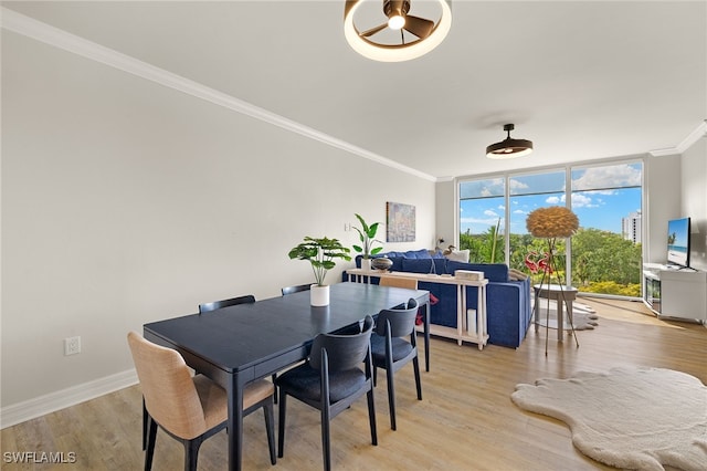 3414 Hancock Bridge Pkwy Unit 502, North Fort Myers, FL 33903 - dining area with crown molding, light wood-type flooring, floor to ceiling windows, and baseboards