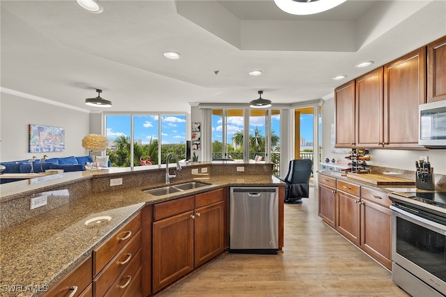3414 Hancock Bridge Pkwy Unit 502, North Fort Myers, FL 33903 - kitchen featuring a sink, stainless steel appliances, recessed lighting, light wood-style floors, and dark stone counters