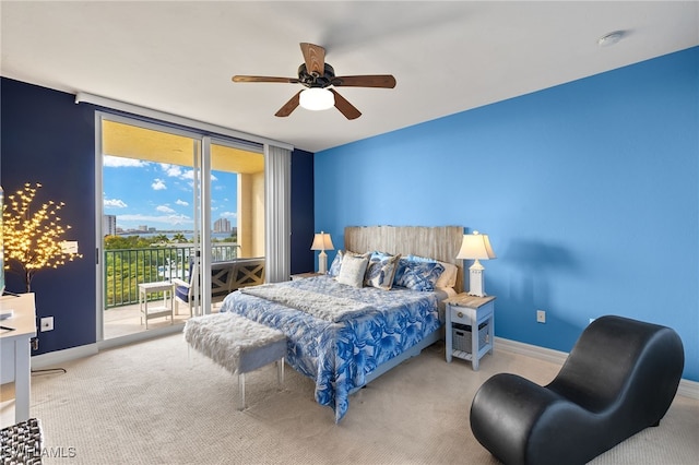 3414 Hancock Bridge Pkwy Unit 502, North Fort Myers, FL 33903 - carpeted bedroom featuring access to outside, baseboards, a ceiling fan, and a wall of windows