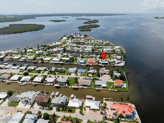 birds eye view of property with a water view and a residential view
