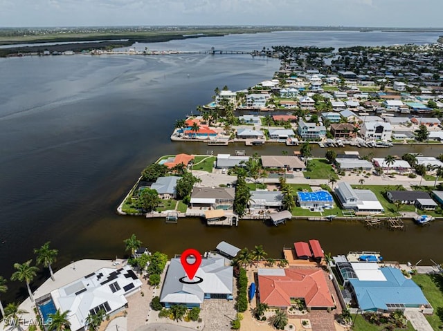 birds eye view of property featuring a water view and a residential view