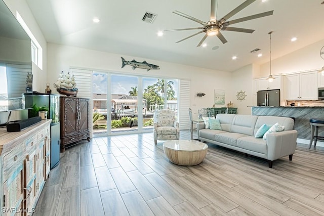 living area with visible vents, a ceiling fan, light wood-style floors, and recessed lighting
