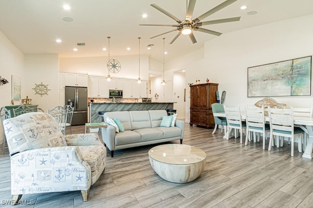 living area with recessed lighting, ceiling fan, and light wood-type flooring