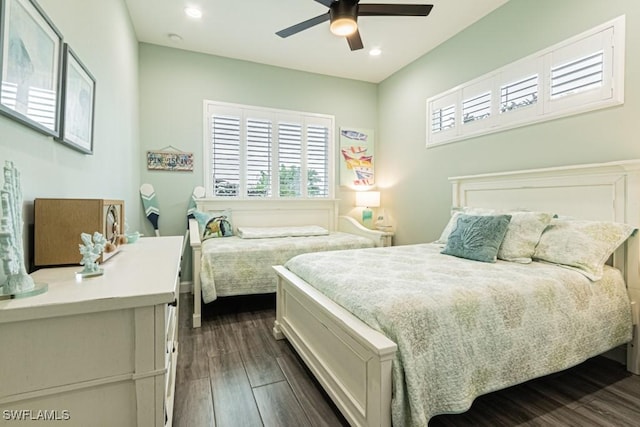 bedroom featuring dark wood-type flooring, recessed lighting, a ceiling fan, and multiple windows