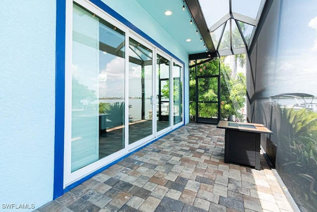 unfurnished sunroom with a skylight