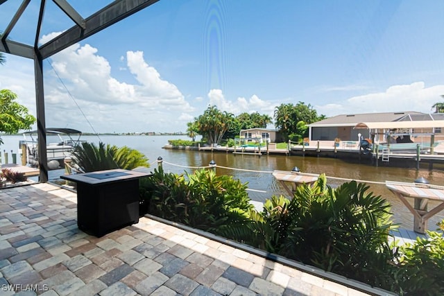 view of patio featuring a water view and a boat dock