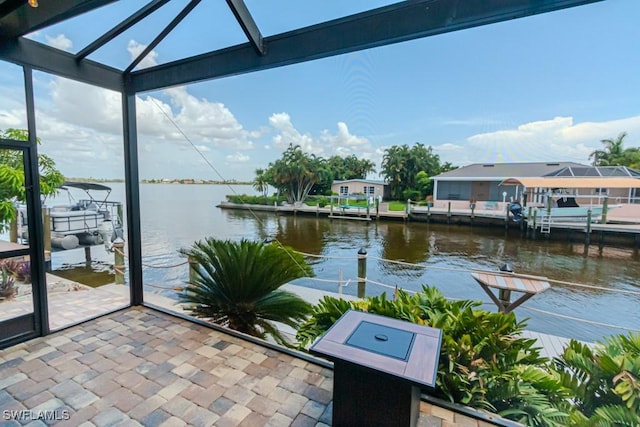 exterior space with glass enclosure and a water view