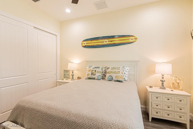 bedroom featuring baseboards, a ceiling fan, a closet, and dark wood finished floors