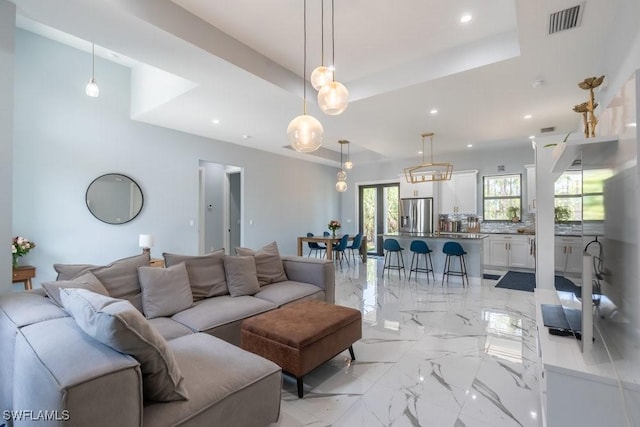 2625 27th Ave NE, Naples, FL 34120 - living area featuring light marble finish floors, recessed lighting, and a tray ceiling