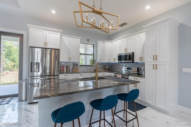 2625 27th Ave NE, Naples, FL 34120 - kitchen with appliances with stainless steel finishes, a sink, light marble finish flooring, decorative backsplash, and recessed lighting