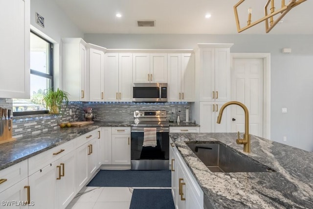 2625 27th Ave NE, Naples, FL 34120 - kitchen with appliances with stainless steel finishes, a sink, tasteful backsplash, white cabinetry, and recessed lighting