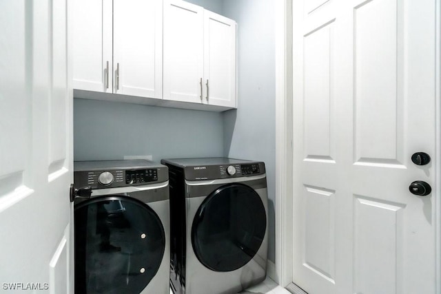 2625 27th Ave NE, Naples, FL 34120 - washroom with washer and dryer and cabinet space