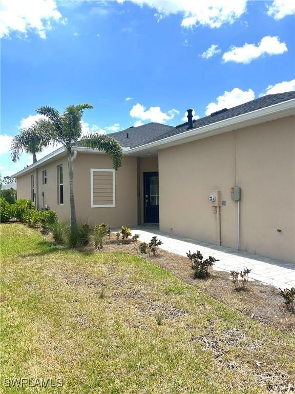view of front of property with a front lawn and stucco siding