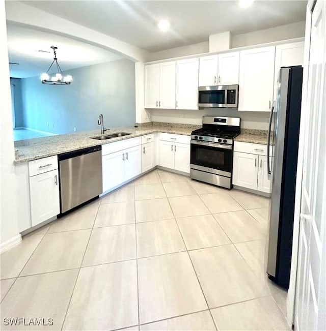 kitchen featuring stainless steel appliances, white cabinetry, and a sink