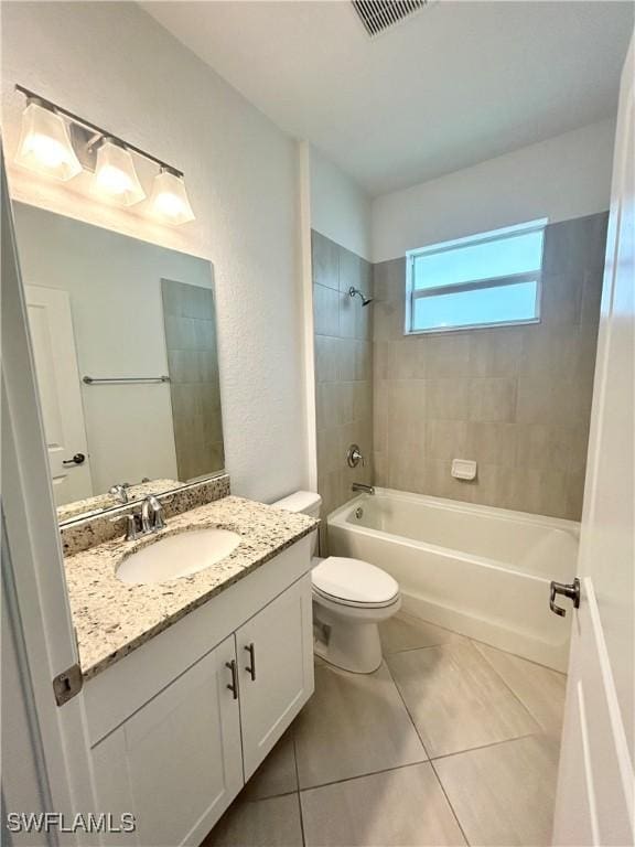 bathroom with visible vents, vanity, toilet, tile patterned floors, and  shower combination