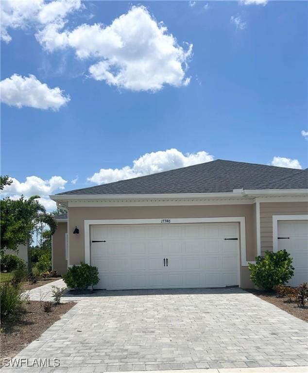 view of front of house featuring decorative driveway and an attached garage