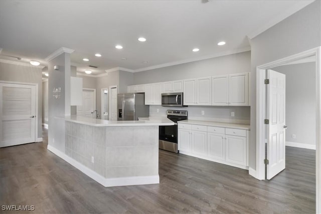 kitchen featuring crown molding, baseboards, light countertops, white cabinetry, and stainless steel appliances