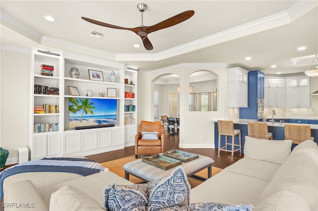 15460 Catalpa Cove Ln, Fort Myers, FL 33908 - living room with a ceiling fan, ornamental molding, arched walkways, wood finished floors, and recessed lighting