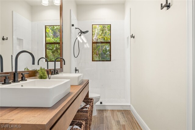 15460 Catalpa Cove Ln, Fort Myers, FL 33908 - full bath with toilet, tiled shower, wood finished floors, and double vanity