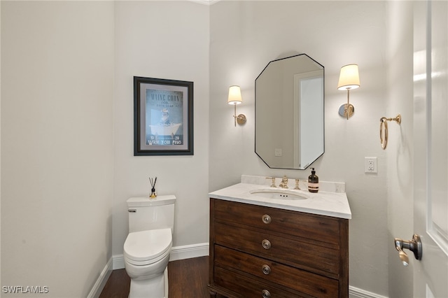 15460 Catalpa Cove Ln, Fort Myers, FL 33908 - bathroom with baseboards, vanity, toilet, and wood finished floors