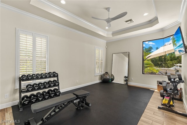 15460 Catalpa Cove Ln, Fort Myers, FL 33908 - workout area featuring a tray ceiling, crown molding, a ceiling fan, wood finished floors, and recessed lighting
