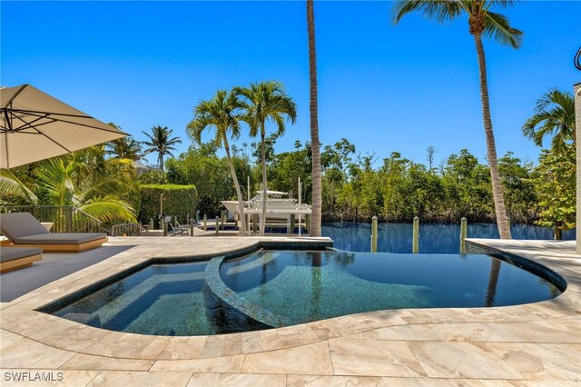 15460 Catalpa Cove Ln, Fort Myers, FL 33908 - view of pool with a pool with connected hot tub, a patio, and fence
