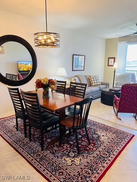 5629 Double Eagle Cir Unit 4224, Ave Maria, FL 34142 - dining room with tile patterned floors and an inviting chandelier
