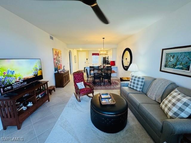 5629 Double Eagle Cir Unit 4224, Ave Maria, FL 34142 - tiled living room with an inviting chandelier and visible vents